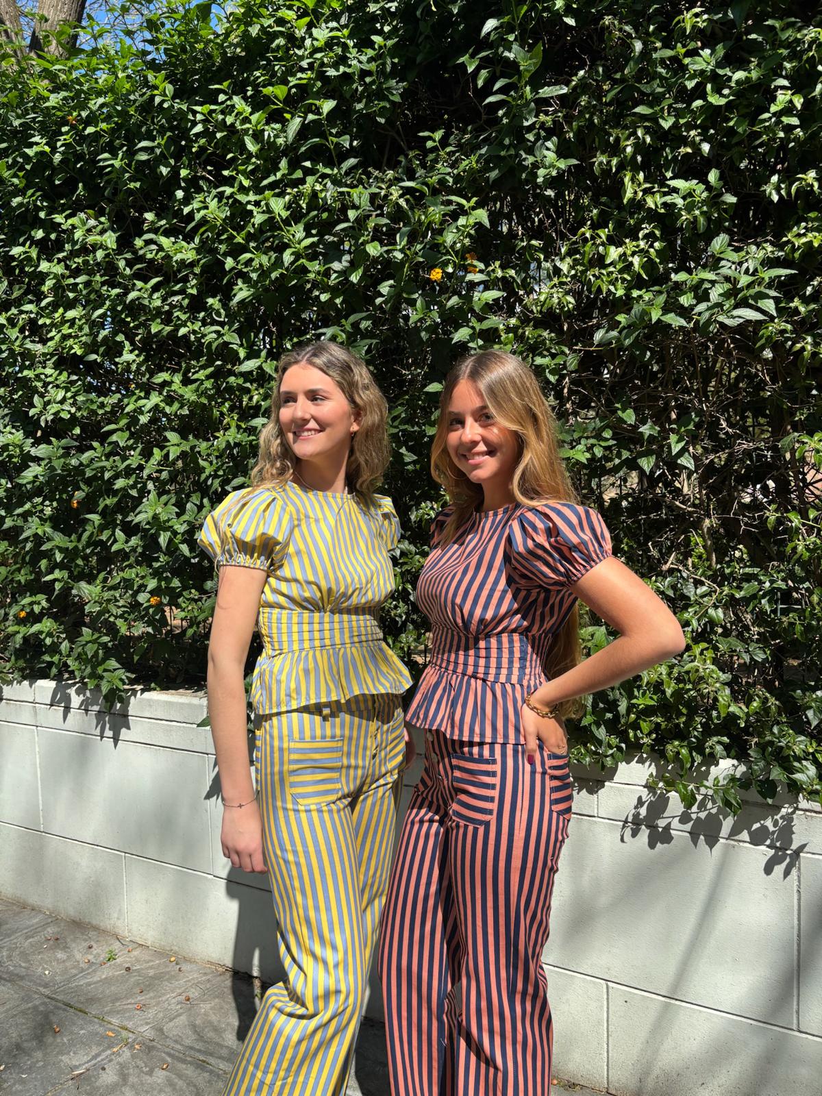 Blusa de rayas  entallada con manga abullonada y volante en la cintura.