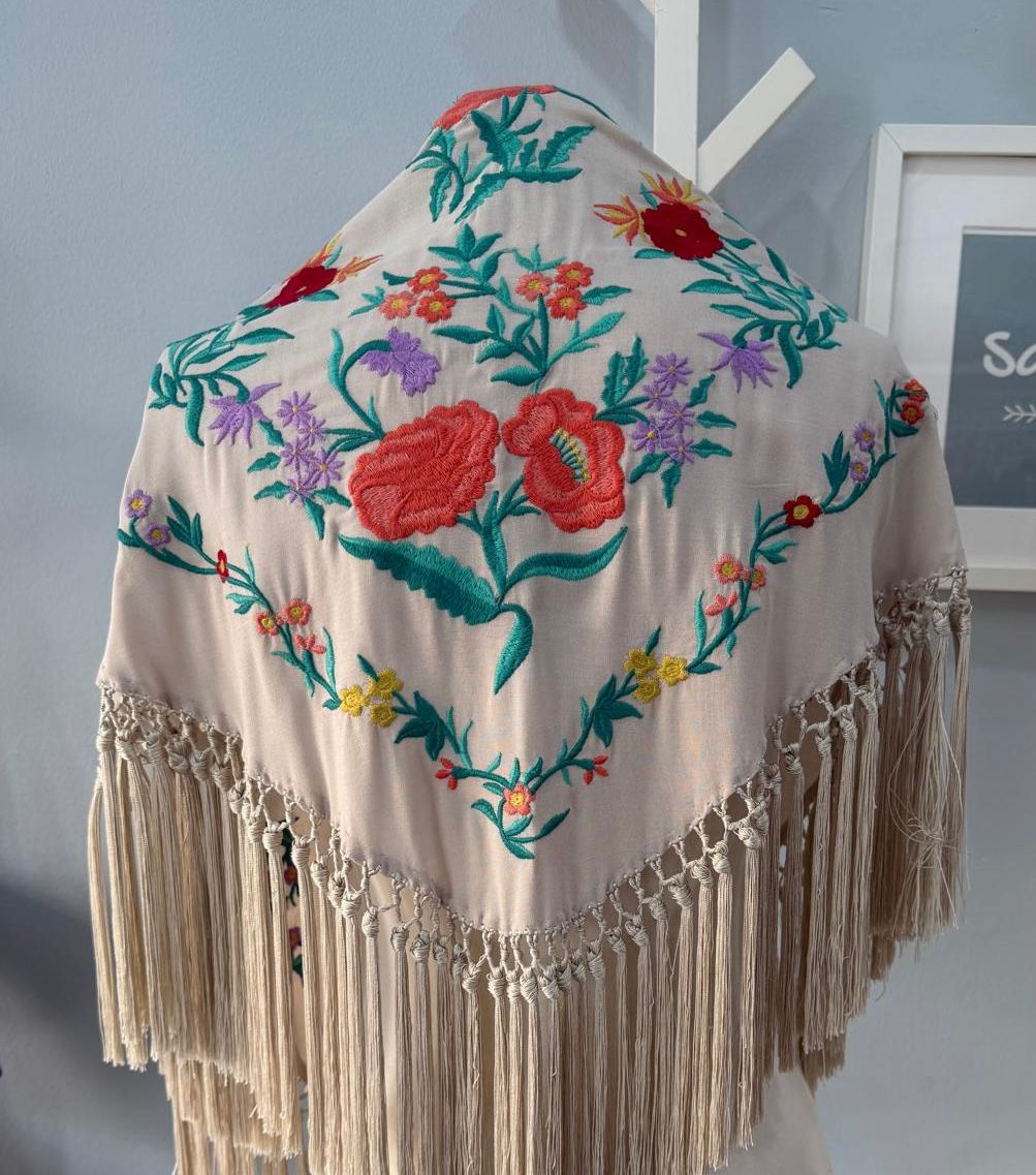 Mantón con bordado floral multicolor en relieve. Acabado con flecos largos anudado artesanal. Ideal par complementar tu traje de flamenca.